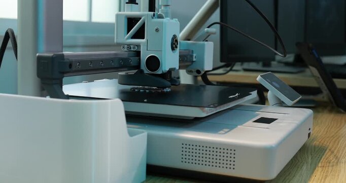Desktop 3d printer printing a small object in a home workshop