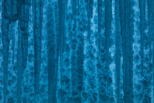 View of frozen icicles hanging over the icy surface of Lake Baikal in Khuzhir, Irkutsk Oblast, Russia.