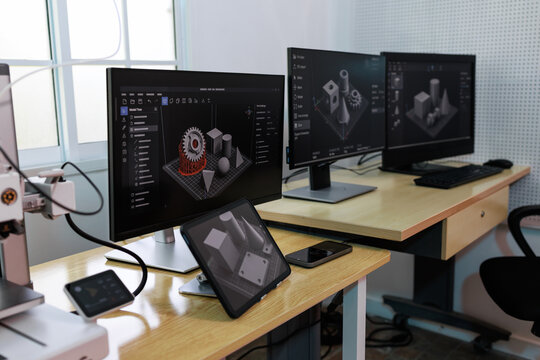 Modern workstation with multiple monitors 3d modeling software in an office lab