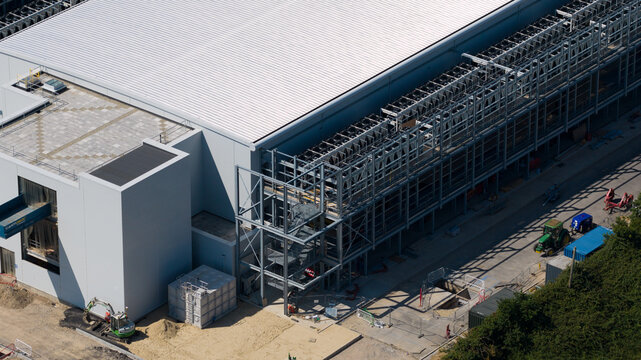 Aerial view of the Kao Data facility featuring modern industrial architecture with a white roof and metal framework in Harlow, England, United Kingdom.