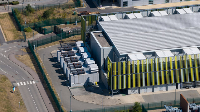 Aerial view of the Kao Data facility featuring modern industrial architecture, cooling infrastructure, and a secure perimeter in Harlow, England, United Kingdom.