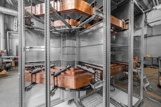 View of industrial electrical switchgear assembly featuring copper busbars and metal framework in Latvia.