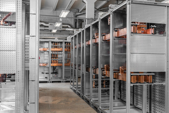 View of industrial electrical switchgear with copper busbars and metal cabinets in a technical facility in Latvia.