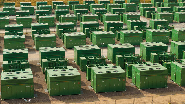 Aerial view of National Grid Hams Hall Battery Energy Storage Systems featuring rows of green lithium-ion battery containers in Birmingham, England, United Kingdom.