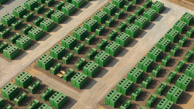 Aerial view of National Grid Hams Hall Battery Energy Storage Systems featuring rows of green lithium ion battery containers arranged in a grid pattern in Birmingham, England, United Kingdom.