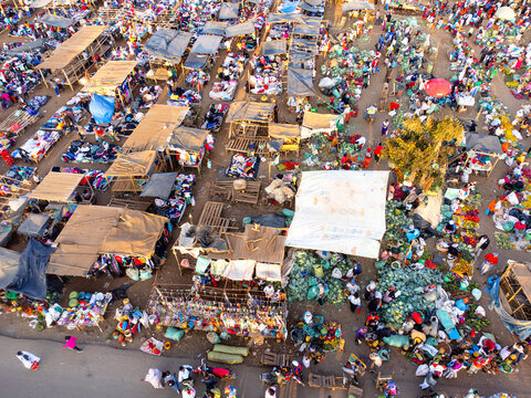 Aerial view of the bustling Kimana market with numerous stalls, vendors, and shoppers navigating the vibrant open-air space in Kimana, Kajiado County, Kenya.