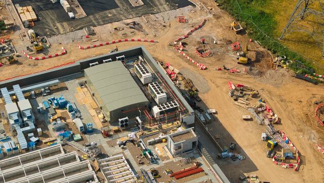 Aerial view of the National Grid Hams Hall Substation and electricity transmission control centre under construction with machinery and materials in Birmingham, England, United Kingdom.
