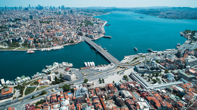 Aerial view of the Golden Horn in Istanbul with bridges, historic mosques, and dense urban cityscape in Turkiye.