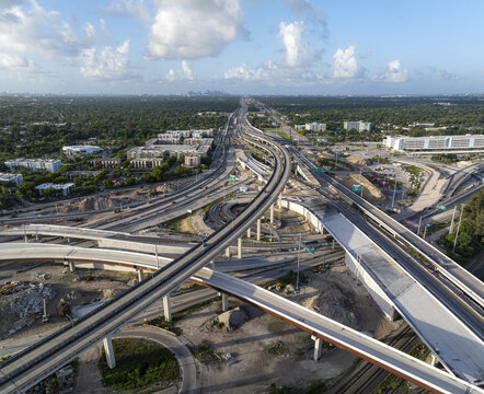 Aerial view of the Golden Glades Interchange featuring complex multi-level highway ramps and concrete overpasses surrounded by urban infrastructure, Miami, Florida, United States.