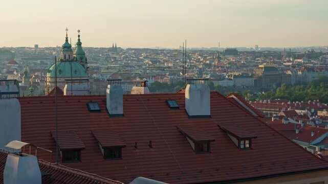 Prague cityscape skyline emerges through predawn haze in soft morning sunlight. Historic Czech capital panorama represents urban travel, European tourism and an authentic city atmosphere.
