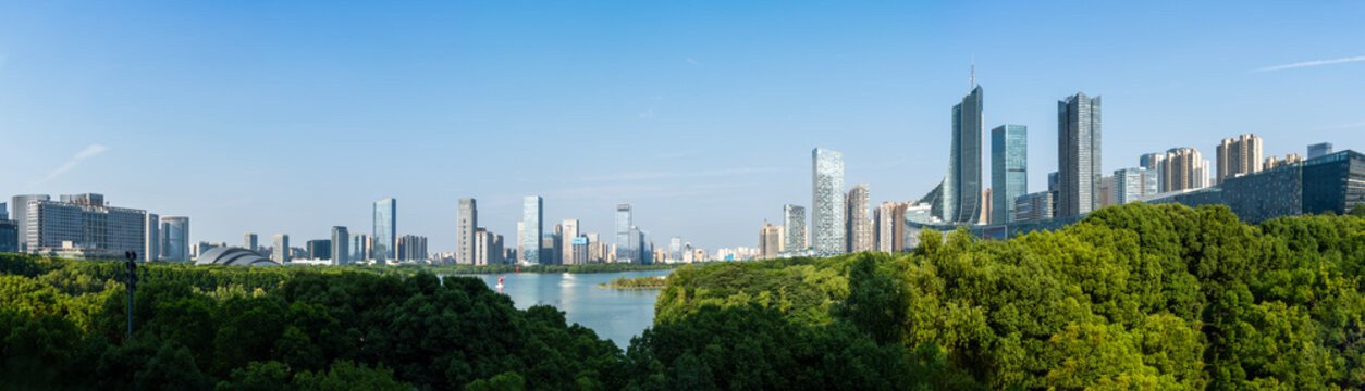 The scenery of Swan Lake in Hefei, Anhui Province, China. Xindi Center and Hefei Radio & Television Center Building stand in the distance, both being landmark buildings of Hefei.