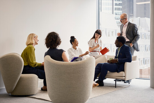 Colleagues discuss business during a meeting in a London office
