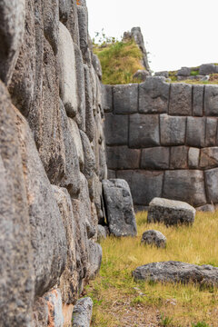 View of the massive interlocking stone walls of the ancient Inca fortress of Sacsayhuaman, featuring precision-cut masonry and dry-stone construction in Cusco, Cusco, Peru.