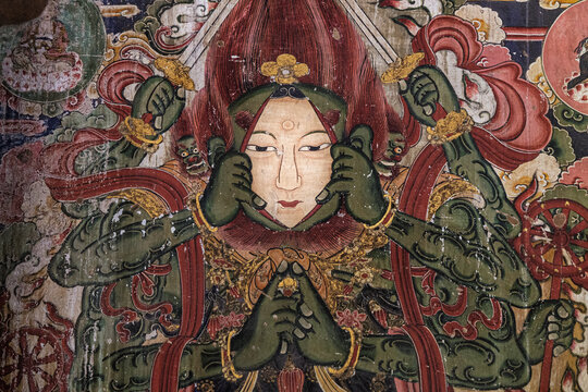 View of the intricate Buddhist mural painting at Yong'an Monastery featuring a multi-armed deity with green skin and traditional details in Datong, Shanxi, China.