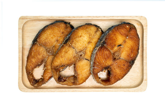 Fried King Mackerel  in a wooden tray on isolated white background, Top view.