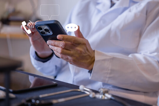 Doctor using smartphone for online communication, messaging and telemedicine in a modern clinic, representing digital healthcare, mobile technology, medical support and remote consultation.