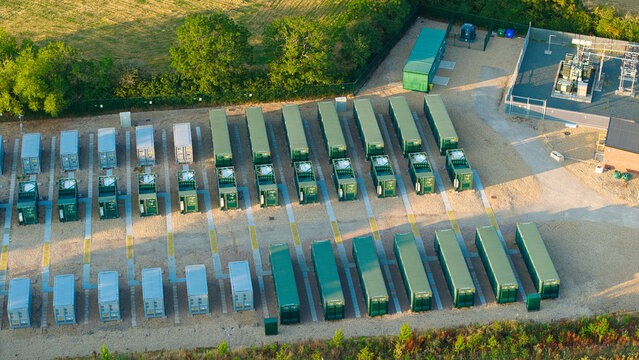 Aerial view of the Enderby Substation National Grid featuring rows of green battery energy storage system containers on a gravel site in Leicester, England, United Kingdom.
