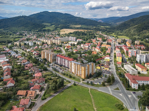 Aerial view of the Housing estate sidlisko 1. maja featuring residential apartment buildings surrounded by lush greenery and roads in Hnusta, Banska Bystrica Regio, Slovakia.