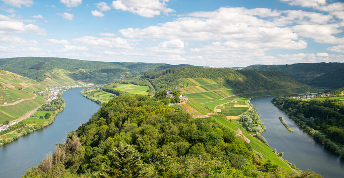 Aerial view of the Zeller Hamm Moselle river loop with Marienburg castle on the hilltop surrounded by vineyards and forest in the Mosel valley, Bullay, Rhineland-Palatinate, Germany.