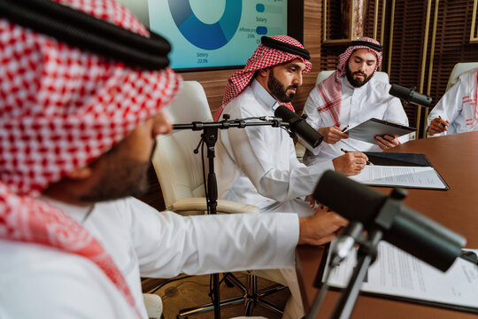Arab business professionals collaborating during a podcast meeting presentation