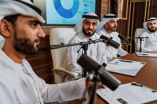 Arab business leaders broadcasting podcast discussion in studio