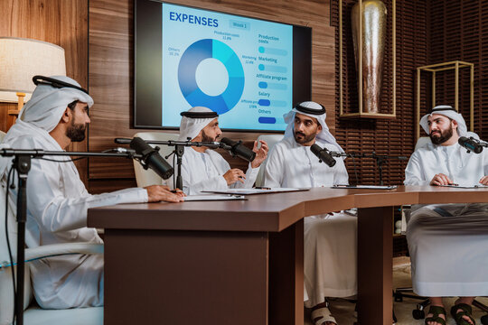 Arab business leaders broadcasting podcast discussion in studio