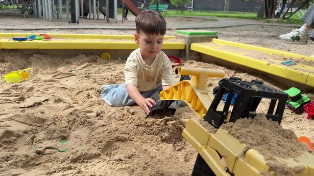 Toddler playing with toy excavator