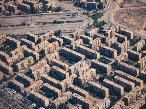 Aerial view of a dense residential district with rows of uniform apartment buildings and paved streets in Cairo, Cairo Governorate, Egypt.