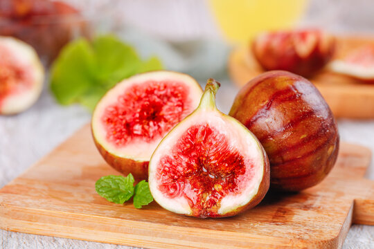 Fresh Ripe Figs with Red Flesh on Wooden Board - Healthy Organic Fruit