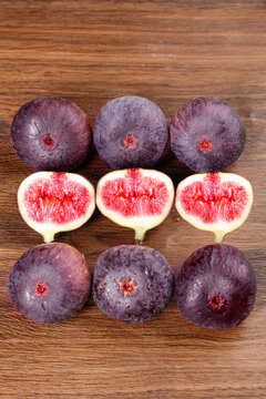 Fresh Yunnan Figs with Red Flesh on Wood Background