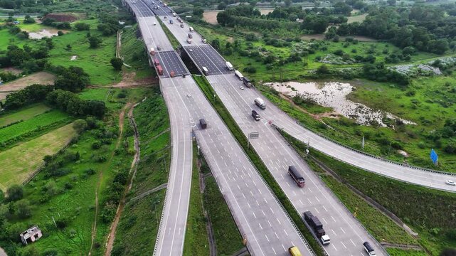 Scenic Aerial View of the Exit Ramp of the Delhi&ndash;Mumbai Expressway Featuring Modern Highway Interchange, Multi-Lane Roads, Smooth Traffic Flow, Advanced Road Infrastructure and Breathtaking Drone Pers