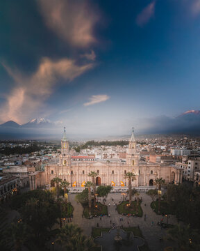 Aerial view of Arequipa Cathedral and the Plaza de Armas surrounded by colonial architecture and palm trees with the Misti volcano in the background in Arequipa, Arequipa, Peru.
