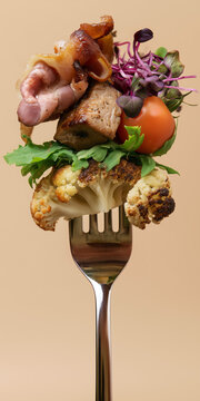 Gourmet roasted meat, bacon and vegetables arranged on a fork