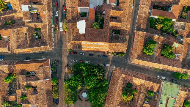 Aerial view of the historic town of Suchitoto with terracotta rooftops, narrow streets, and a central plaza with a fountain surrounded by trees in Suchitoto, Cuscatlan Department, El Salvador.