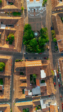 Aerial view of the historic town square and Santa Lucia Church surrounded by colonial architecture with terracotta rooftops and cobblestone streets, Suchitoto, Cuscatlan Department, El Salvador.