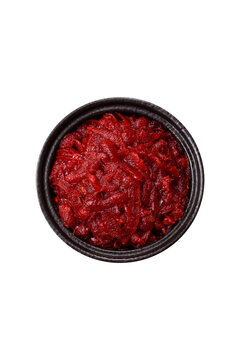 Grated beetroot with salt and spices as an ingredient for borscht or a vegan salad. Grated beetroot