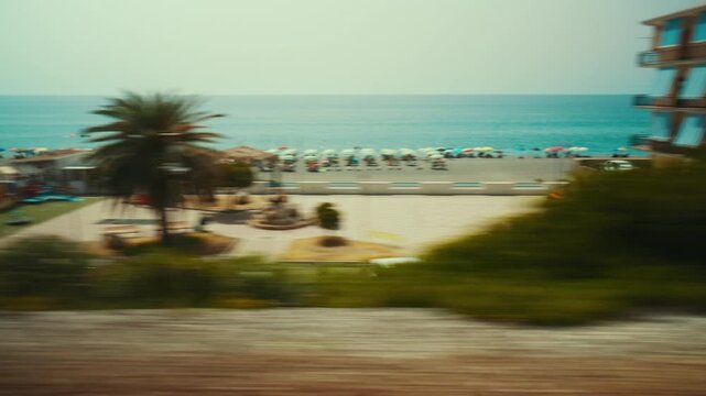 Italian beaches seen from a train window, with tourists in summer