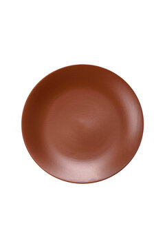 An empty round ceramic plate on a dark, textured brown background. An empty round plate