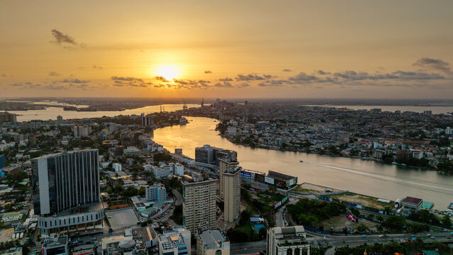 Aerial view of Lagos Island skyline with modern skyscrapers and dense urban development along the Lagos Lagoon during a golden sunset in Lagos, Lagos, Nigeria.