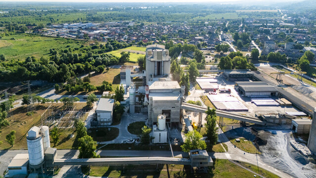 Aerial view of the Holcim Srbija cement factory complex featuring industrial silos, conveyor belts, and processing buildings in Beocin, Vojvodina, Serbia.
