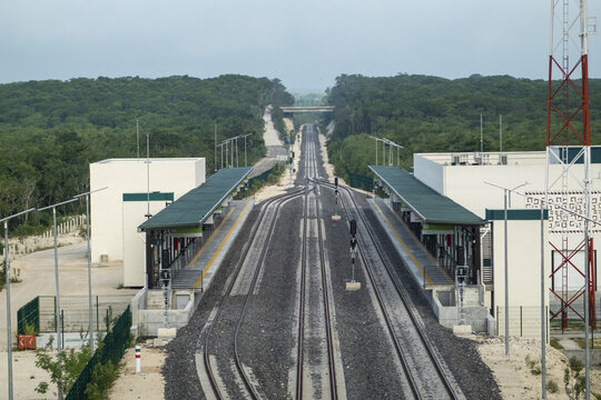 View of the Tren Maya railway station with modern platforms and tracks surrounded by dense jungle in Calakmul, Campeche, Mexico.