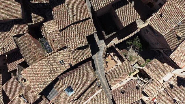 Top down aerial shot of pretty medieval clay rooftops in village of Alqu&eacute;zar, Spain. 