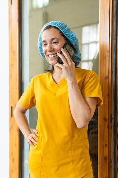 Beekeeper worker talking on mobile phone smiling