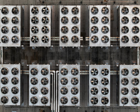 Aerial view of industrial cooling fans on a data center rooftop in Cambridge, Massachusetts, United States.