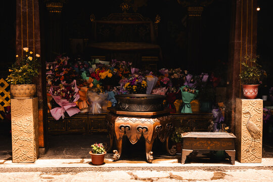 View of a traditional incense burner and floral offerings at a shrine in Lhasa, Tibet, China.