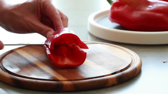 Sliced Fresh Red Bell Pepper on Wooden Cutting Board Close Up