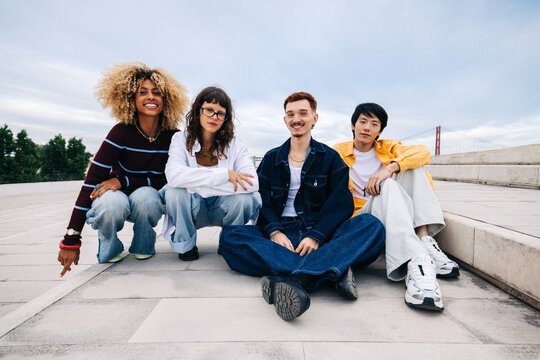 Diverse group of friends sitting together and smiling