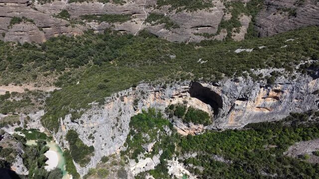 Aerial of barren landscape with mountains and camera tilting downwards towards gorge in Aragon province, Spain. 