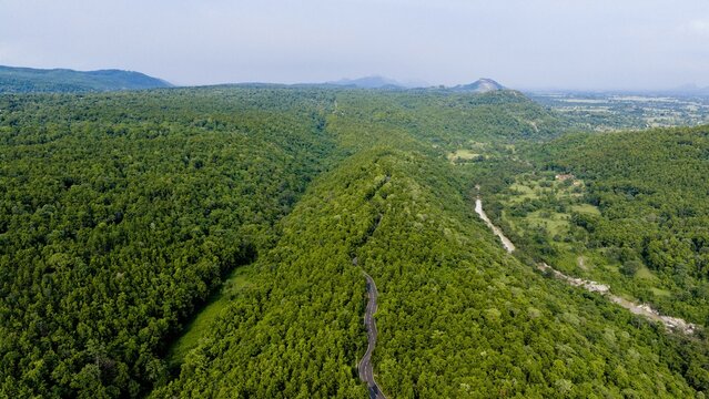 Aerial view of the winding Sita Fall Road cutting through the lush green forest landscape in Bijulia, Jharkhand, India.