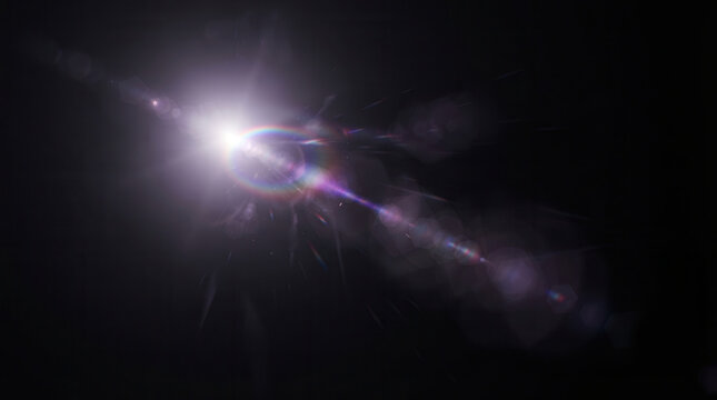 Cosmic Lens Flare Celestial Light Beam Prismatic Glow Stellar Flare in Darkness Radiant Light Streak